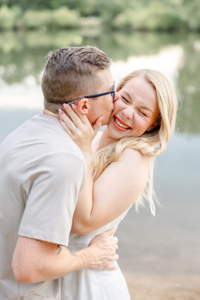 groom kissing bride in sioux falls for engagement photo